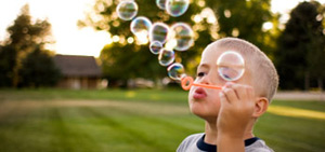 boy blowing bubbles